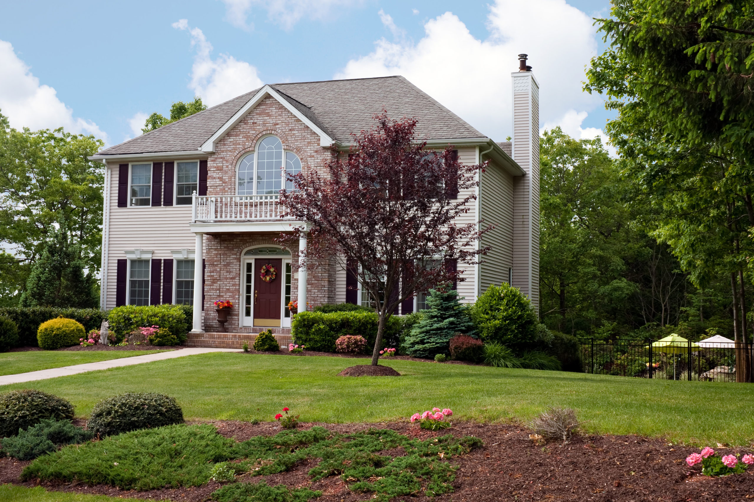 A modern custom built luxury home in a residential neighborhood. This high end house is very nicely landscaped property.